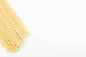 Free photo uncooked spaghetti pasta on white.