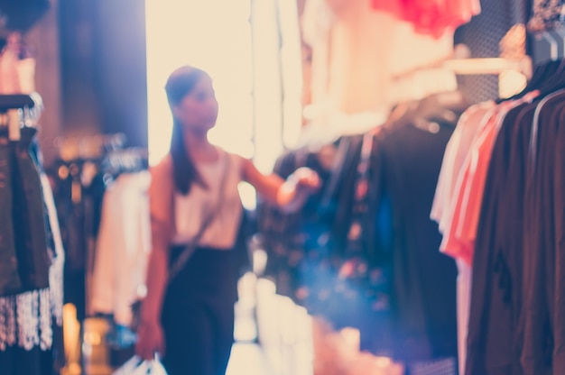 Free Photo unfocused background with woman in a clothing store