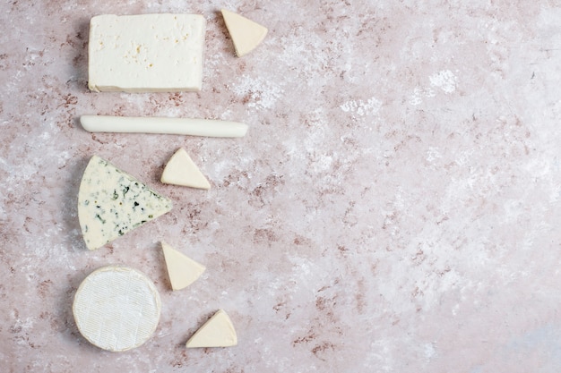 Free photo various types of cheese on light  brown surface