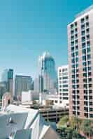 Free photo vertical shot buildings in downtown austin and a tall glass building in texas, usa