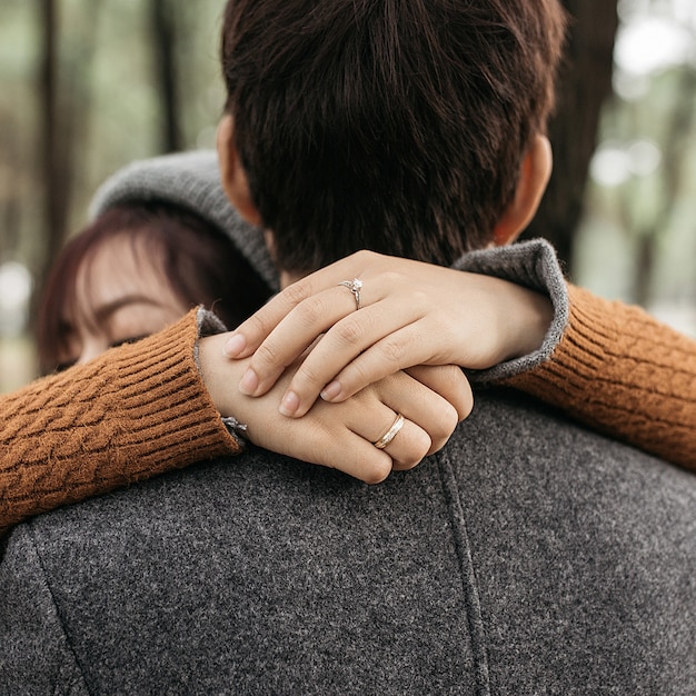 Free photo vertical shot of a couple hugging each other in love