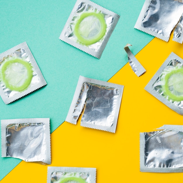 Free photo above view condoms on green and yellow background