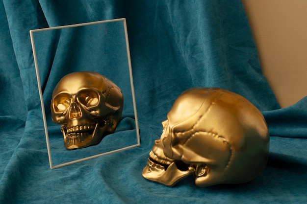 Free Photo view of golden skull with mirror