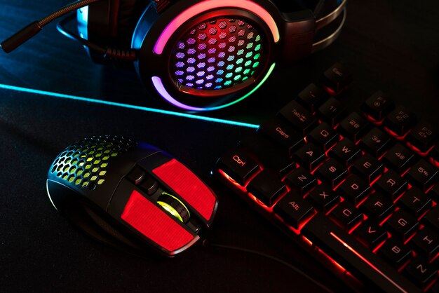 View of neon illuminated gaming desk setup with keyboard