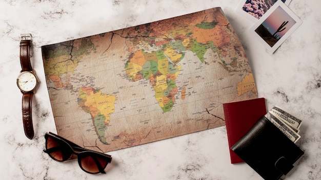 Free photo view of world travel map and travel essentials