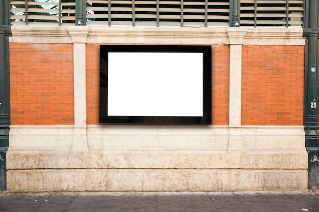 Free Photo white billboard on wall in city