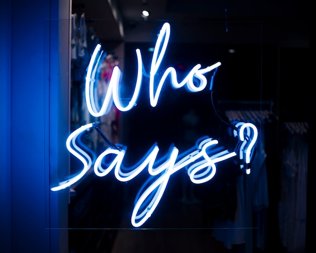 Who says? quote sign in neon lights 