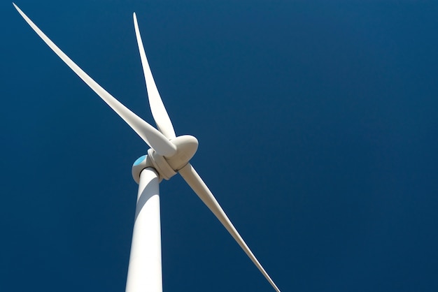 Free photo wind turbine against deep blue sky