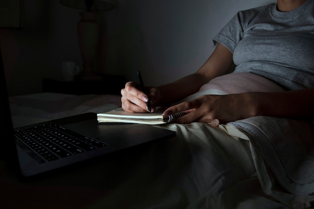 Woman in bed working late