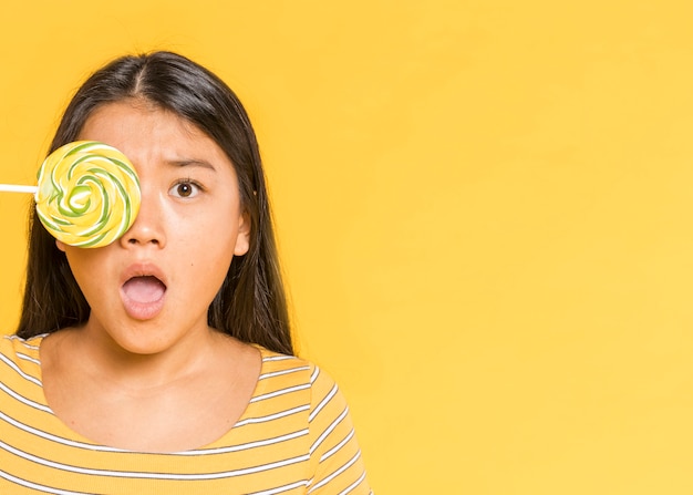 Free photo woman covering her eye and being surprised