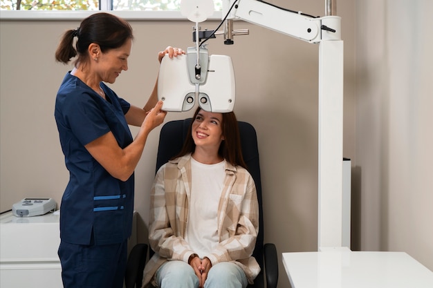 Free photo woman getting an eye exam at the ophthalmologist office