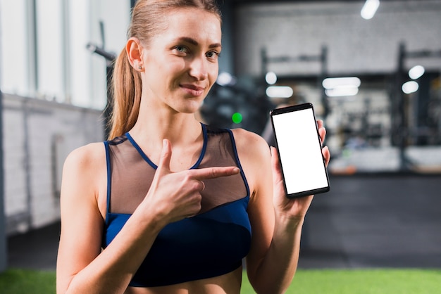 Free photo woman in gym with smartphone template