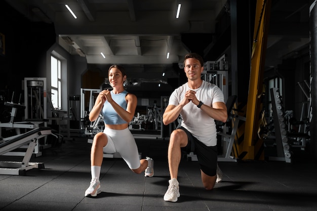 Free photo woman helping man at gym