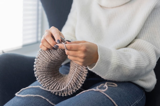 Free photo woman at home knitting close up