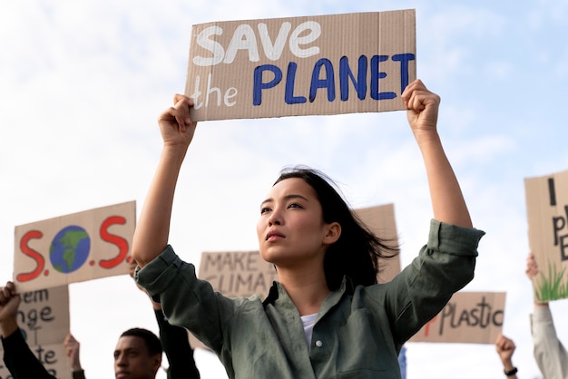 Free photo woman joining a global warming protest