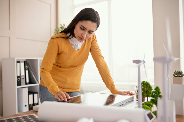 Free photo woman at office working at environment project