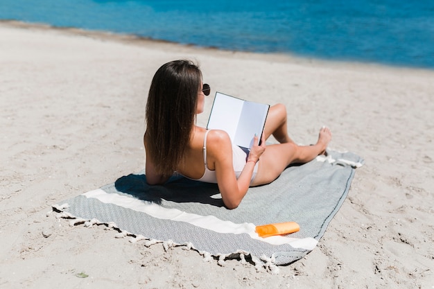 Free Photo woman reading book near water