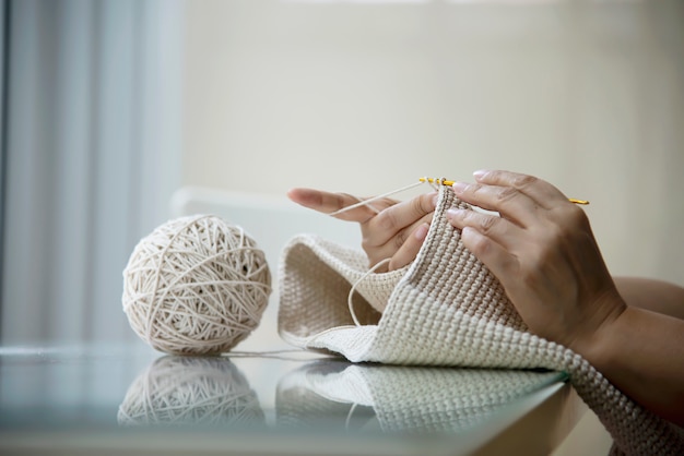 Free photo woman's hands doing home knitting work