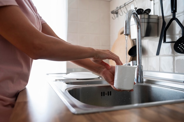 Free photo woman washing her white mug