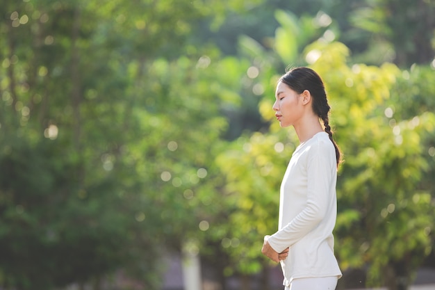 Foto gratuita donna in abito bianco meditando nella natura