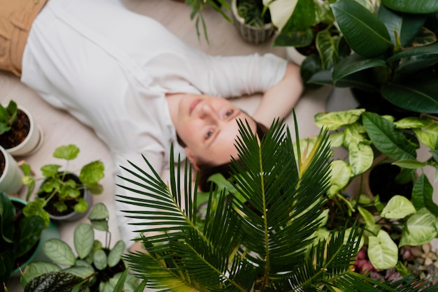 Free photo woman with plants frame