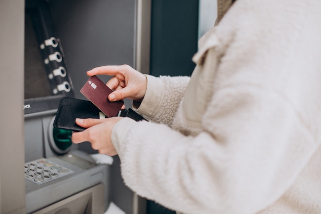 Free Photo woman withdrawing money at atm outside the street