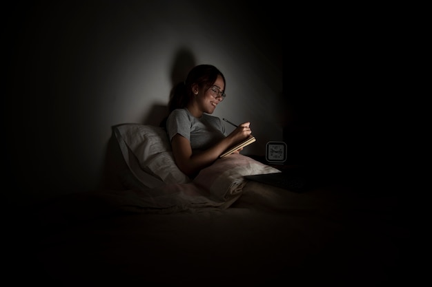 Free Photo woman working late at home while in bed