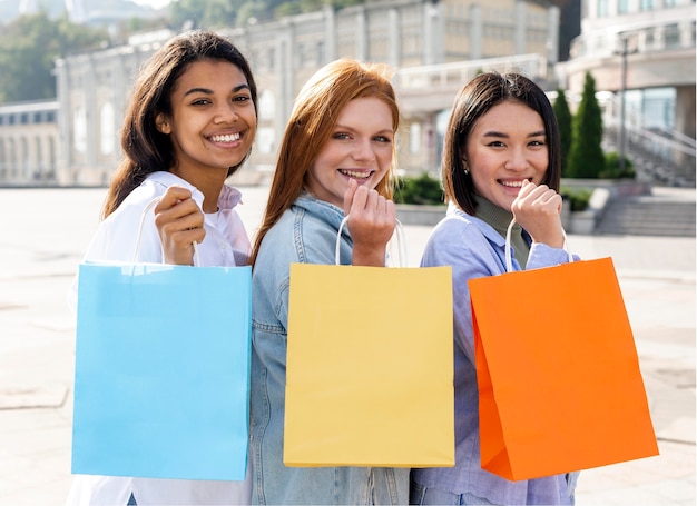 Free photo women shoeing their shopping bags