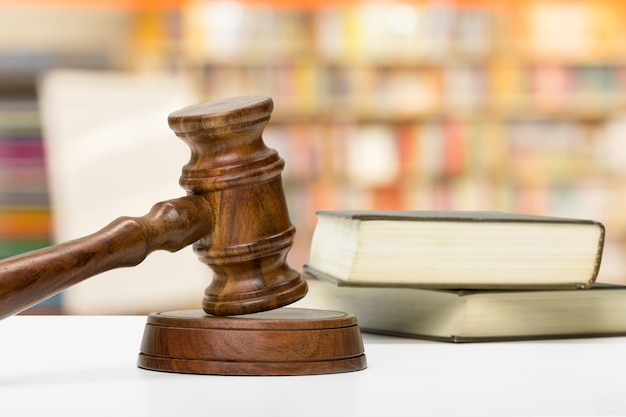 Free Photo wooden gavel and books on wooden table