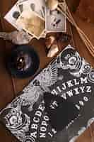 Free photo wooden ouija board and old photos top view