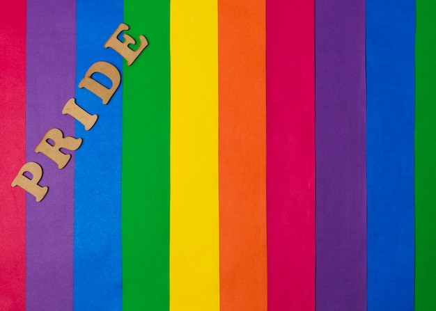 Free Photo wooden pride word and bright gay flag