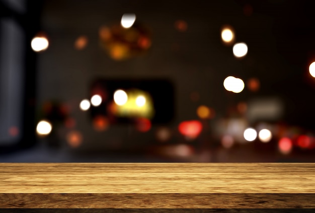 Free photo wooden table looking out to a defocussed room interior