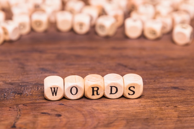 Free Photo word text on wooden dices above brown desk