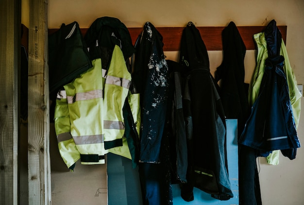 Free photo workwear coats and jackets hanging on a rack