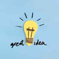 Free photo yellow light bulb with great idea text on blue background