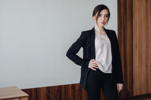 Free Photo young attractive emotional girl in business-style clothes in an office or audience