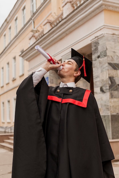 Free photo young boy happy to graduate