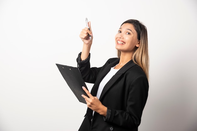 Free Photo young business woman holding clipboard . 