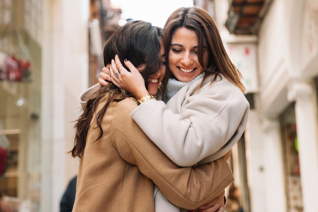 Free photo young content women embracing in love