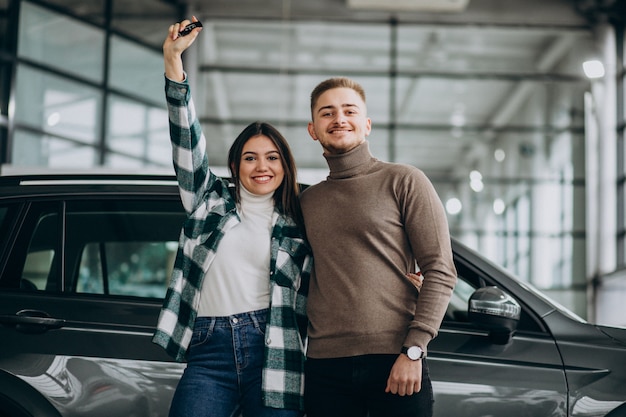 Free Photo young couple choosing a car in a car show room