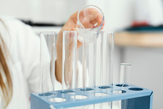 Free Photo young girl scientist with test tubes