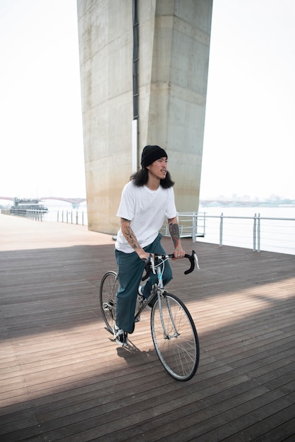 Free photo young man riding his bike