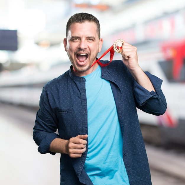 Young man wearing a blue outfit. With a gold medal.