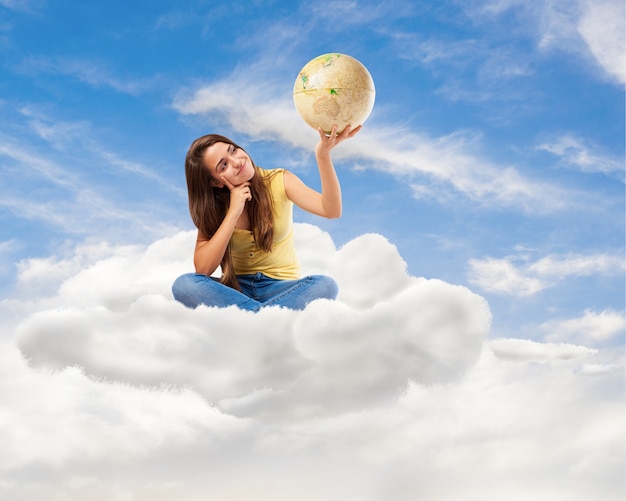 young student woman looking her world globe sitting on a cloud