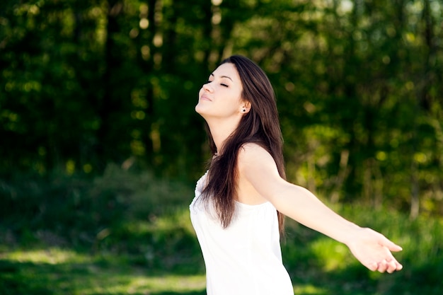 Free Photo young woman enjoying the summer in a park