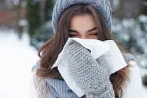 Free photo young woman snoozing in winter