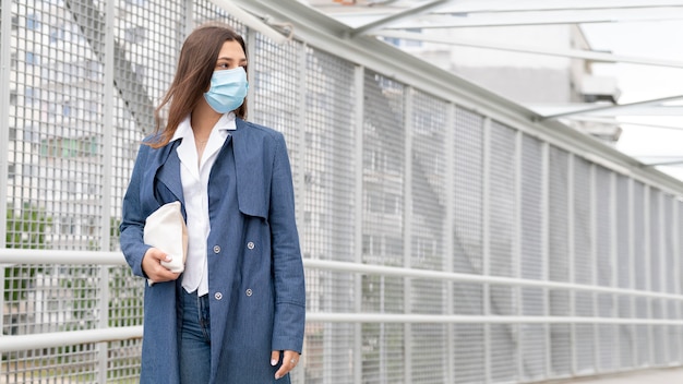 Free photo young woman wearing face mask medium shot