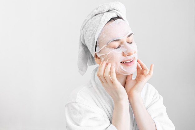 Free Photo young woman with sheet mask on her face spa procedure