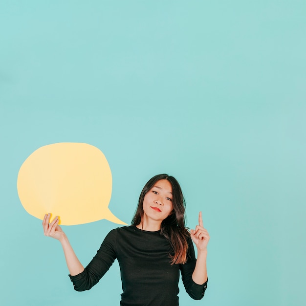 Free Photo young woman with speech bubble pointing up