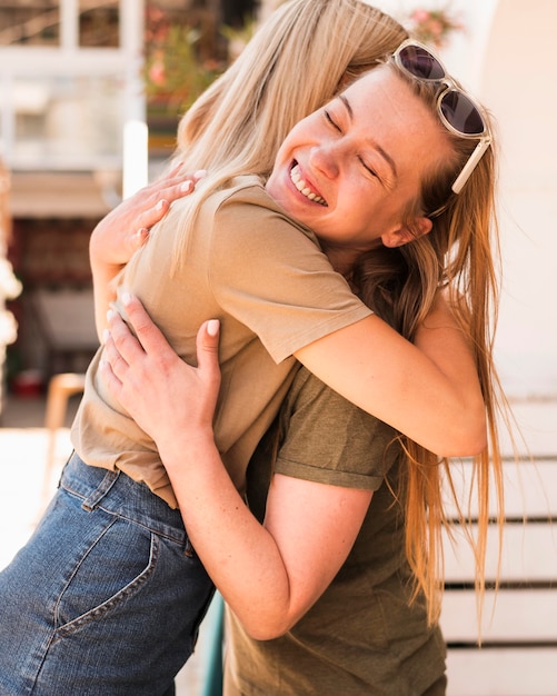 Free photo young women hugging each other